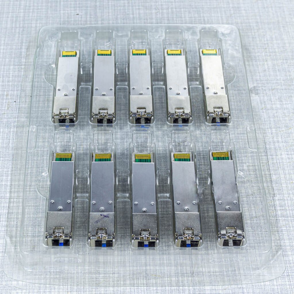 Top view of multiple SFP fiber optic transceiver modules arranged in a plastic tray, designed for high-speed network and data center connectivity.