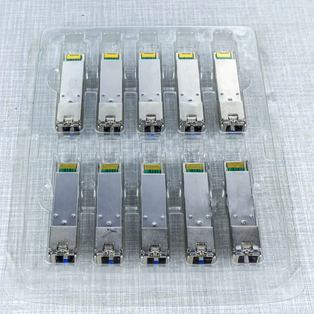 Top view of multiple SFP fiber optic transceiver modules arranged in a plastic tray, designed for high-speed network and data center connectivity.